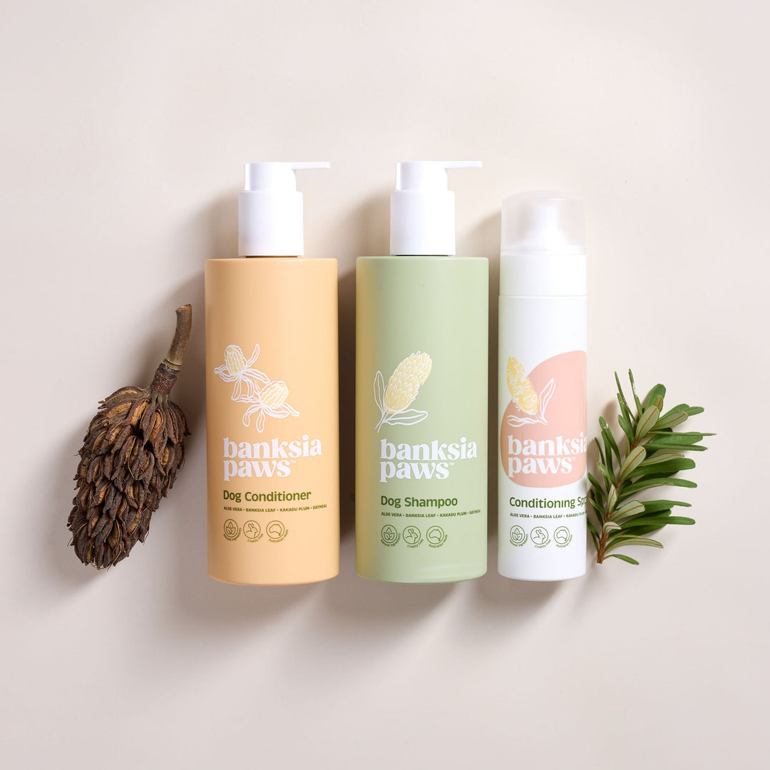 Classic Bundle - Three bottles of Danksin Paws pet care products on a beige background with natural elements.