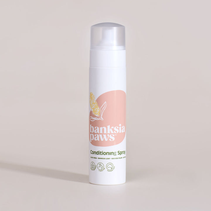 Banksia Paws conditioning spray bottle on a beige background