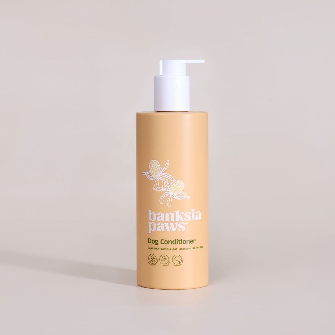 Bottle of 'Banksia Paws' dog conditioner on a beige background