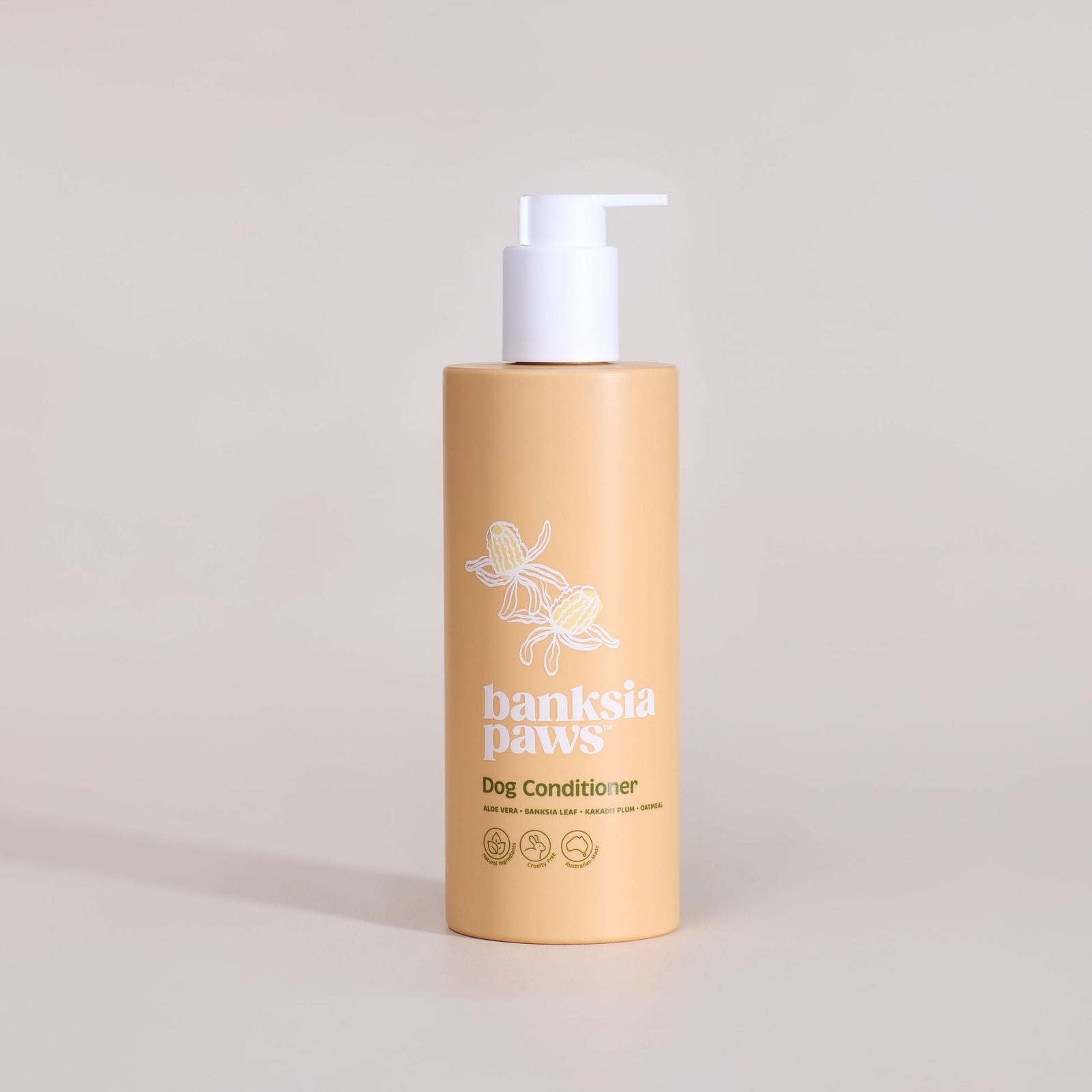 Bottle of 'Banksia Paws' dog conditioner on a beige background