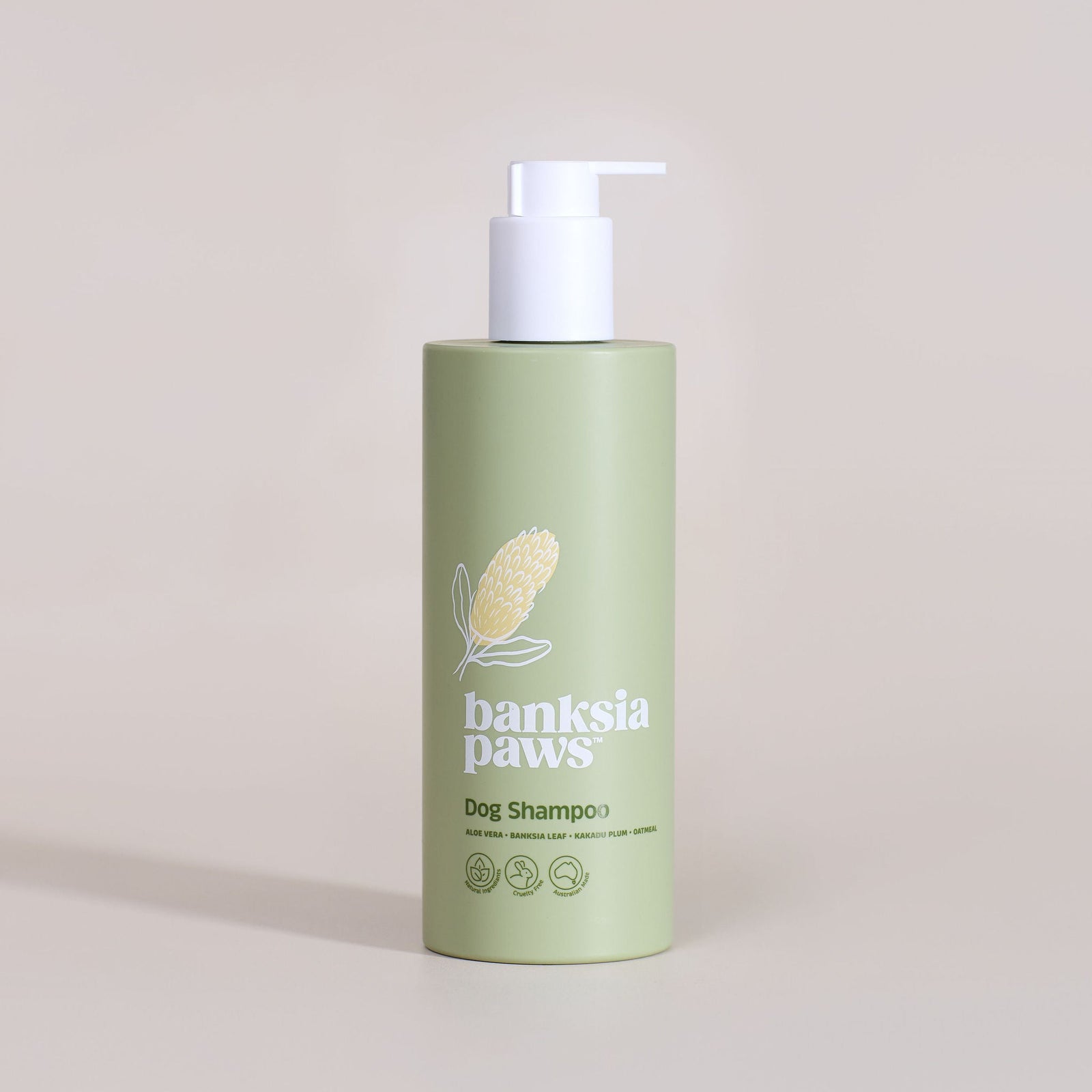 Banksia Paws dog shampoo bottle on a beige background