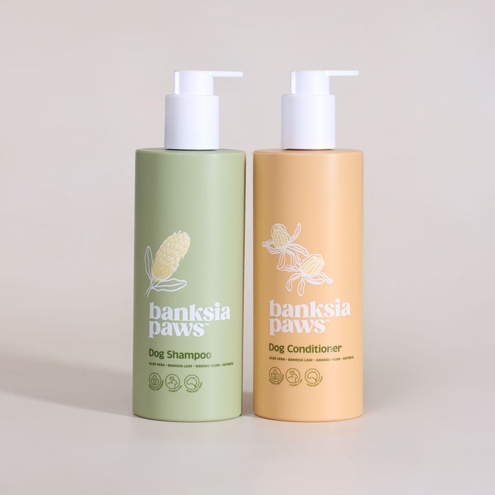 Two bottles of banksia paws dog shampoo and conditioner on a beige background