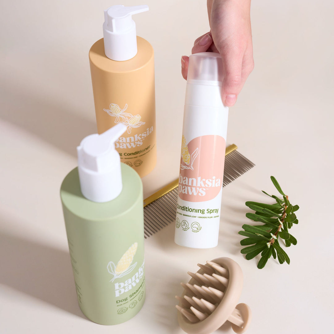 Ultimate Starter Bundle - Set of dog grooming products including bottles, a spray bottle, and a brush on a neutral background.